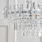 Elegant Jayla 6 light chandelier by TheChandelierCo featuring a modern design with six crystal glass shades and a sleek metallic finish.
