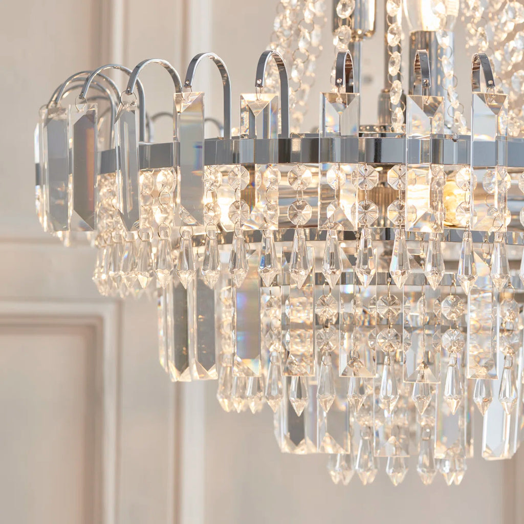 Elegant Jayla 6-light chandelier by TheChandelierCo featuring a modern design with six illuminated glass shades.