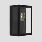 Black outdoor flush mount light fixture by TheChandelierCo, featuring a sleek design suitable for exterior lighting.