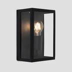 Black outdoor flush mount light fixture by TheChandelierCo, featuring a sleek, modern design suitable for exterior lighting.
