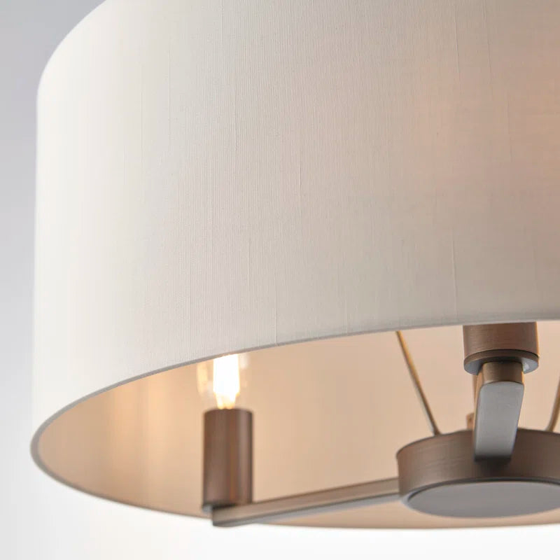 Katrina 3 light drum chandelier by TheChandelierCo featuring a modern drum shade and sleek metal frame hanging from the ceiling.