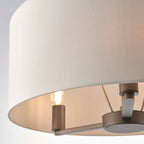 Katrina 3 light drum chandelier by TheChandelierCo featuring a modern drum shade and sleek metal frame hanging from the ceiling.