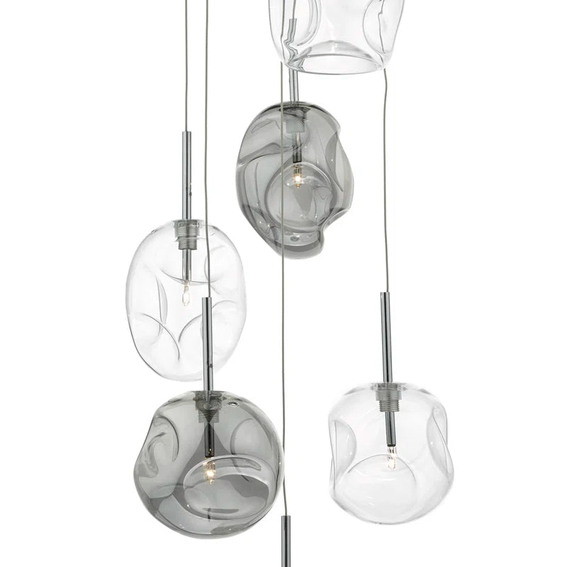 Kensley 6 light chrome cluster pendant lighting fixture with six glass shades hanging in a modern design.