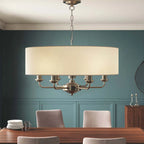 Landover 6 light drum chandelier by TheChandelierCo featuring a sleek drum shade and modern lighting design.