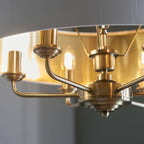 Landover 6-light drum chandelier by TheChandelierCo featuring a modern drum shade and sleek metal finish hanging from the ceiling.