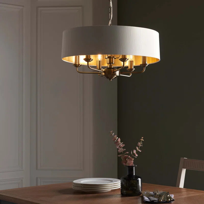 Landover 6 light drum chandelier by TheChandelierCo featuring a modern drum shade with six light bulbs and sleek metal finish.