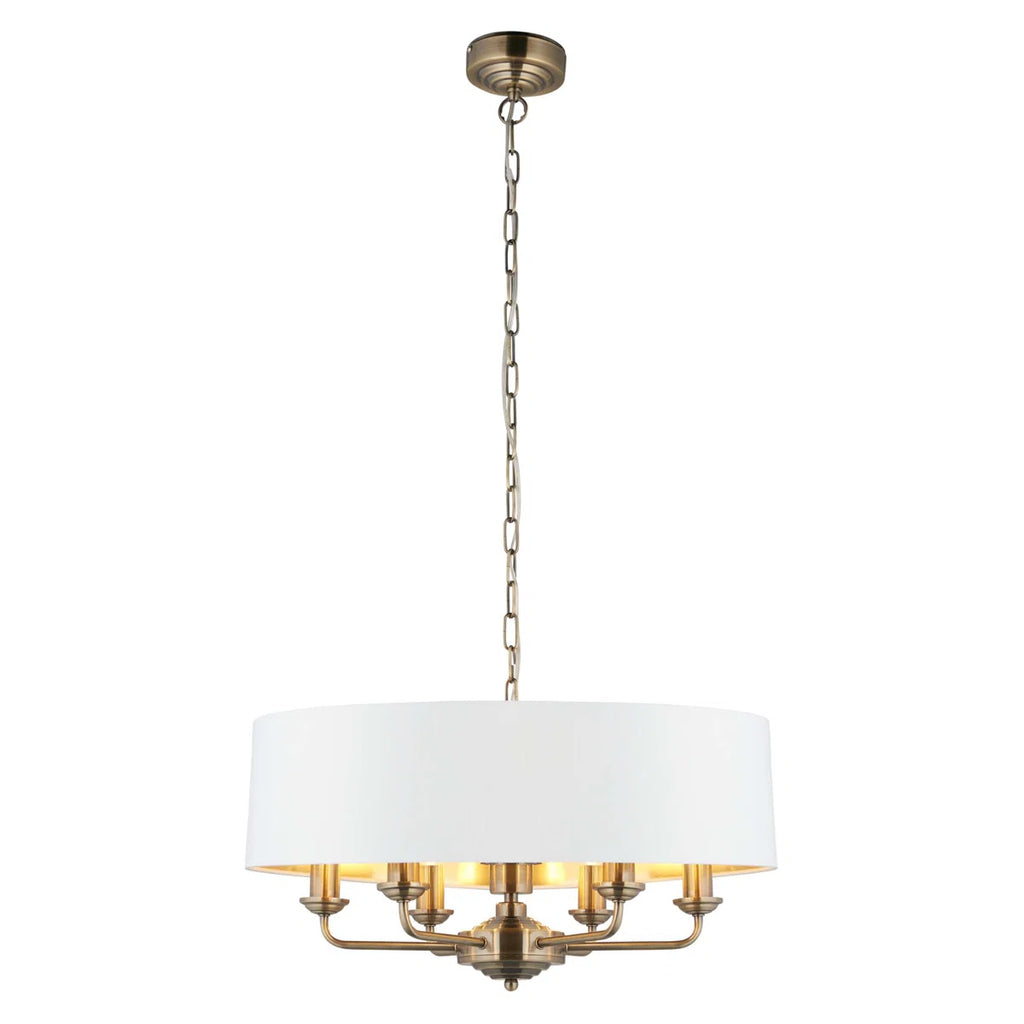 Light drum chandelier with six drum-shaped shades from TheChandelierCo, featuring a modern design and warm ambient lighting.