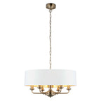 Light drum chandelier with six drum-shaped shades from TheChandelierCo, featuring a modern design and warm ambient lighting.