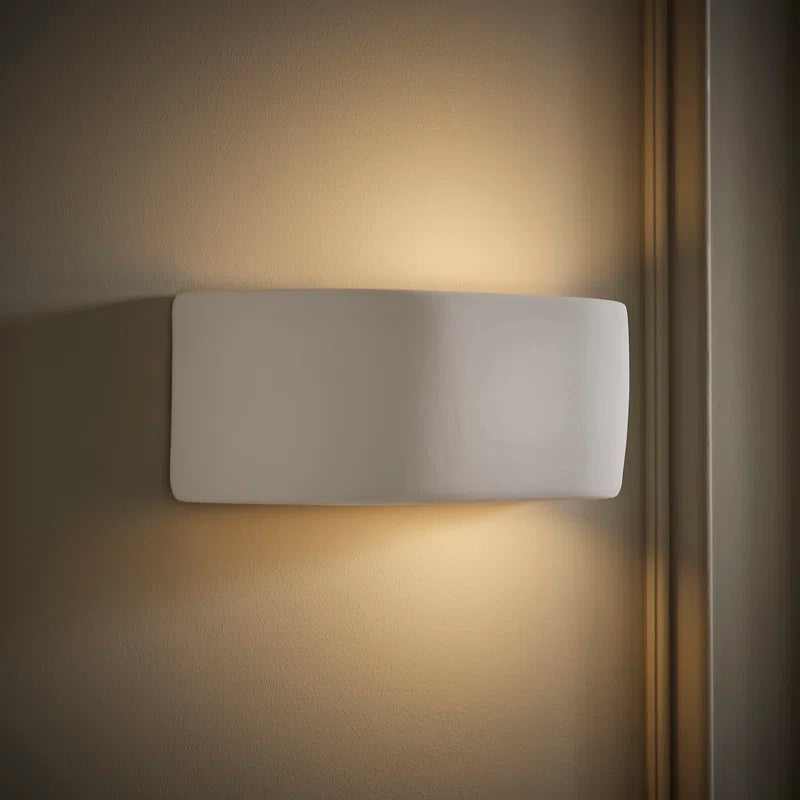 Ceramic flush-mounted sconce by TheChandelierCo featuring a sleek, modern design with a white ceramic finish and soft ambient lighting.