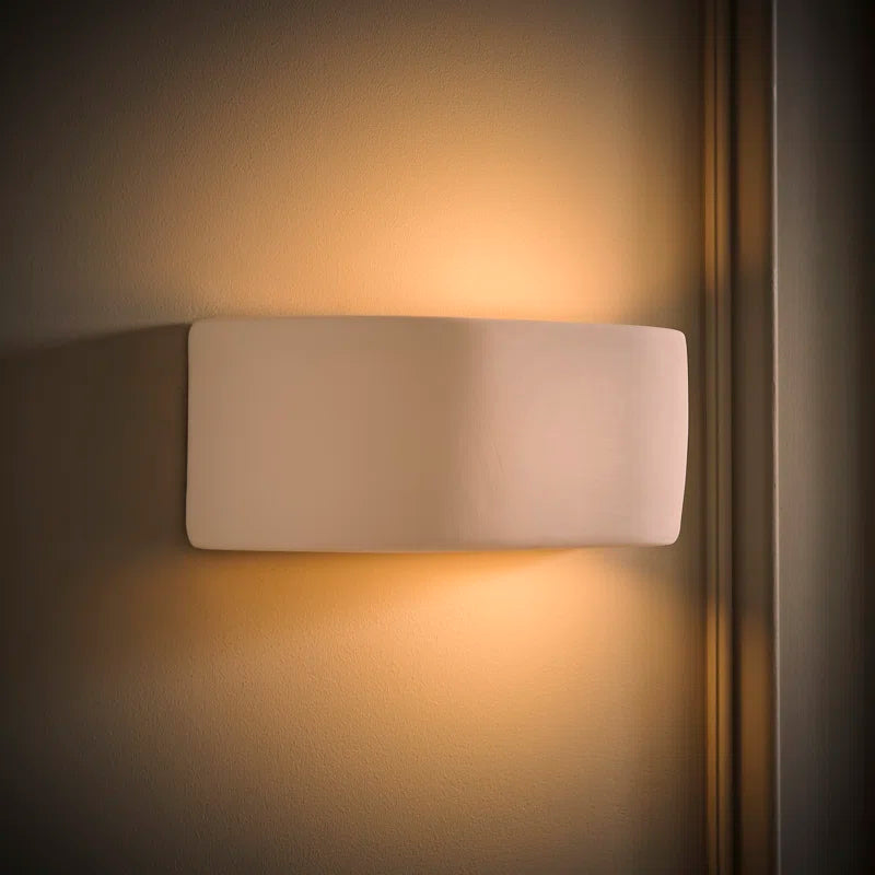 Ceramic flush mounted sconce by TheChandelierCo featuring a sleek, modern design with a white ceramic finish and soft lighting.