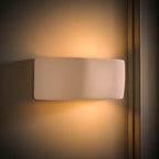 Ceramic flush mounted sconce by TheChandelierCo featuring a sleek, modern design with a white ceramic finish and soft lighting.