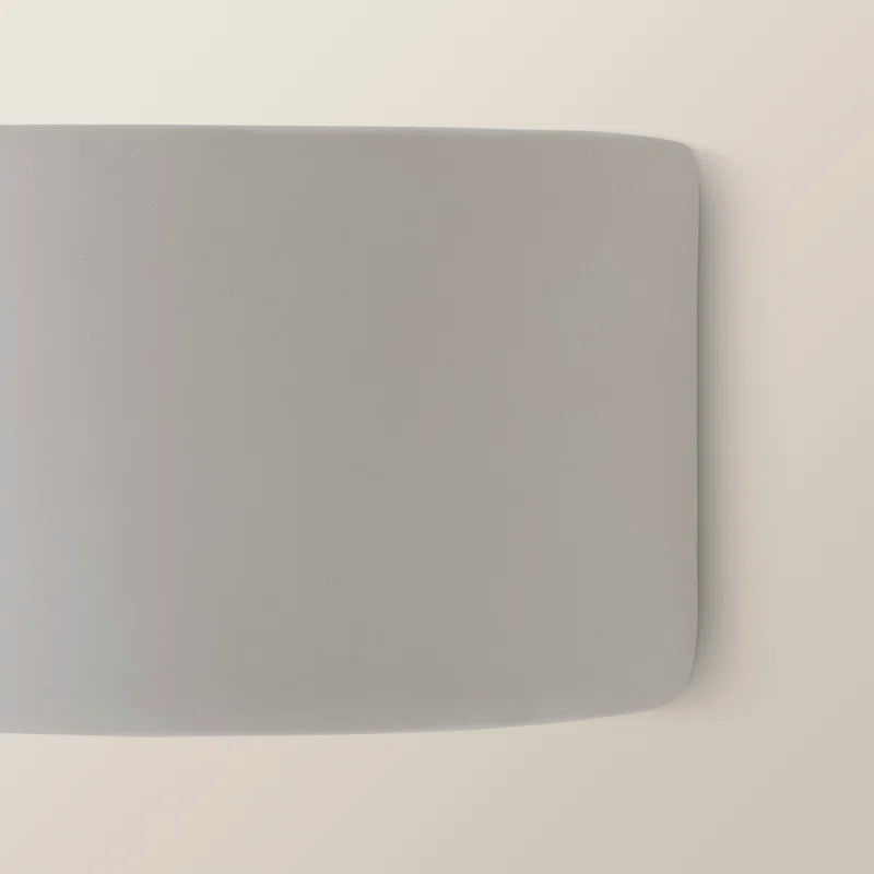 Ceramic flush mounted sconce by TheChandelierCo featuring a sleek, modern design with warm lighting and a smooth finish.