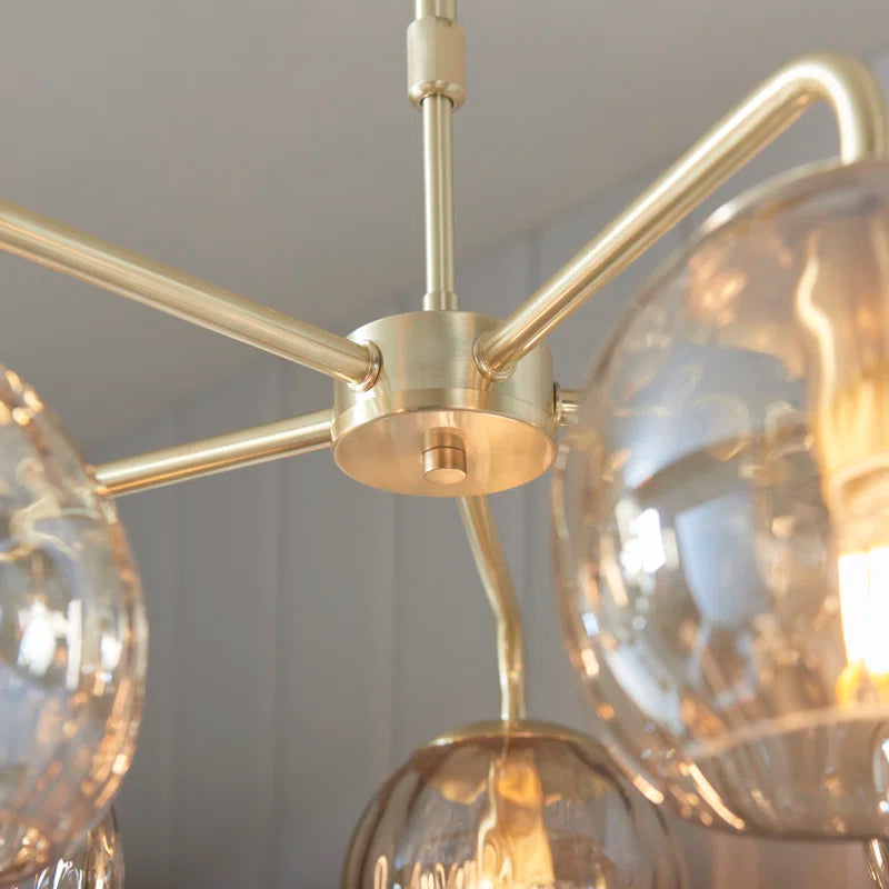 Litchford 5-light chandelier by TheChandelierCo with black metal frame and clear glass globes, hanging from a ceiling.