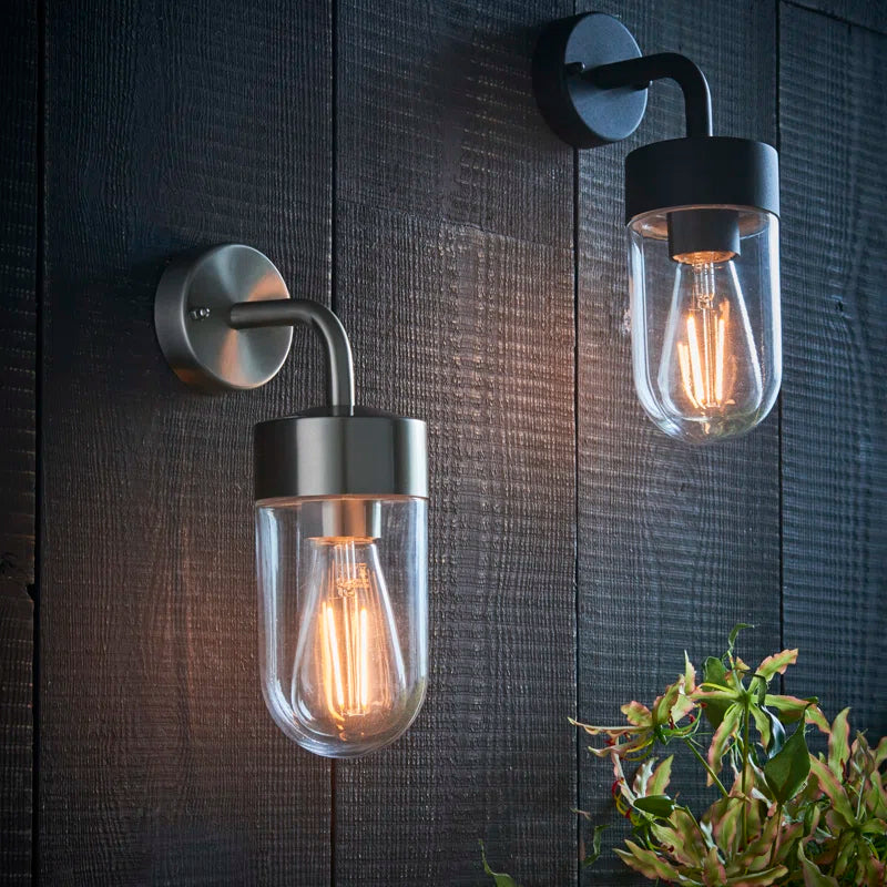 Myla 21cm H outdoor wall lantern by TheChandelierCo featuring classic black metal design with glass panels for exterior lighting.
