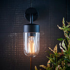 Myla 21cm outdoor wall lantern by TheChandelierCo featuring classic black metal design and clear glass panels on a wall mount.