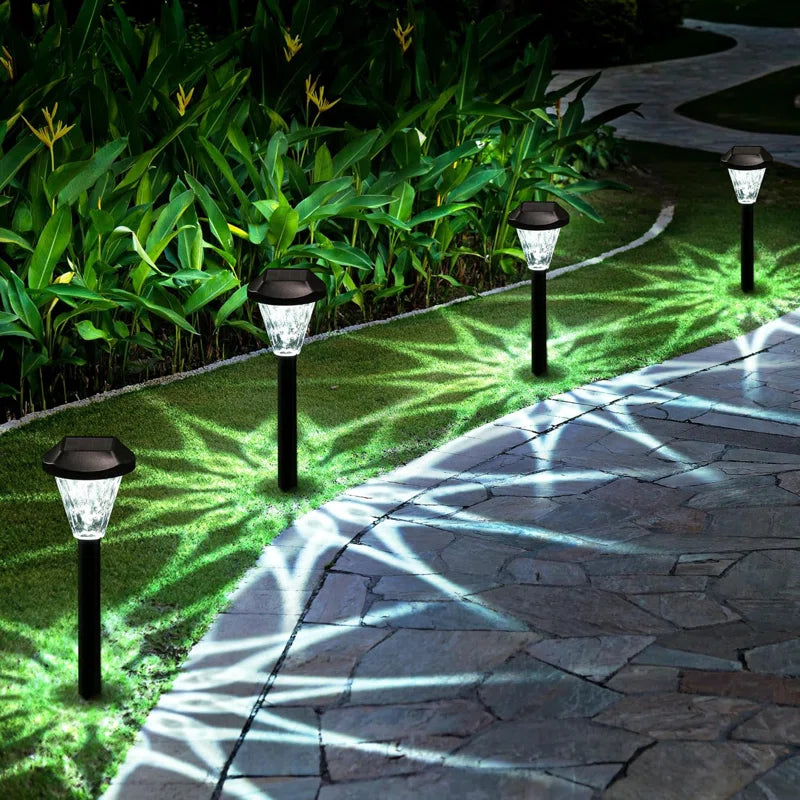 Set of 10 plastic solar-powered pathway lights by TheChandelierCo, outdoor garden lights with stakes and LED solar panels.