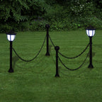 Set of two solar-powered LED pathway lights by TheChandelierCo with integrated lights and sleek garden stake design.