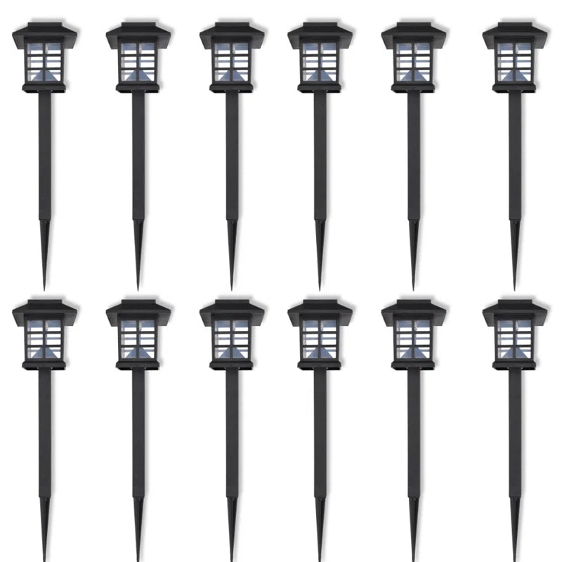 Set of 12 solar-powered LED pathway lights by TheChandelierCo, with integrated lights and sleek design for outdoor illumination.