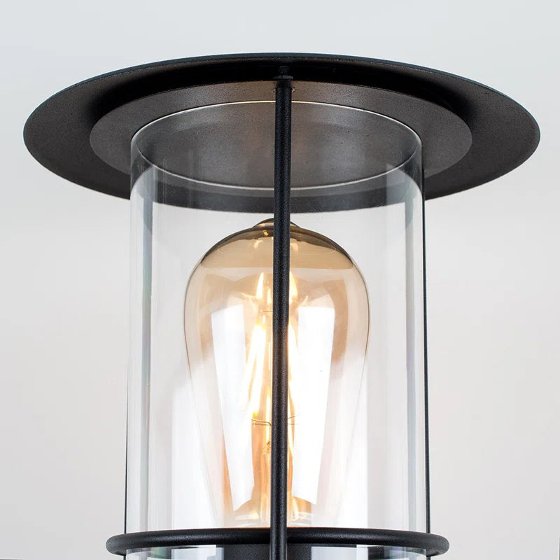 Black outdoor wall lantern with classic design and clear glass panels, suitable for outdoor lighting by TheChandelierCo.