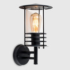 Black outdoor wall lantern with a classic design and clear glass panels, perfect for exterior lighting.