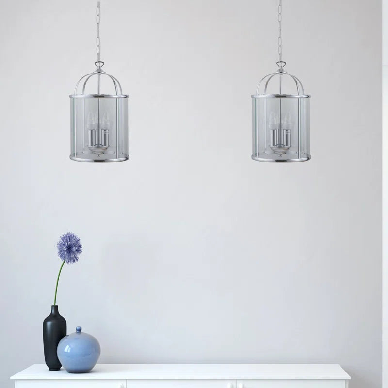 Strasburg 3-light lantern pendant by TheChandelierCo featuring vintage-style metal frame and glass lanterns hanging from a ceiling mount.