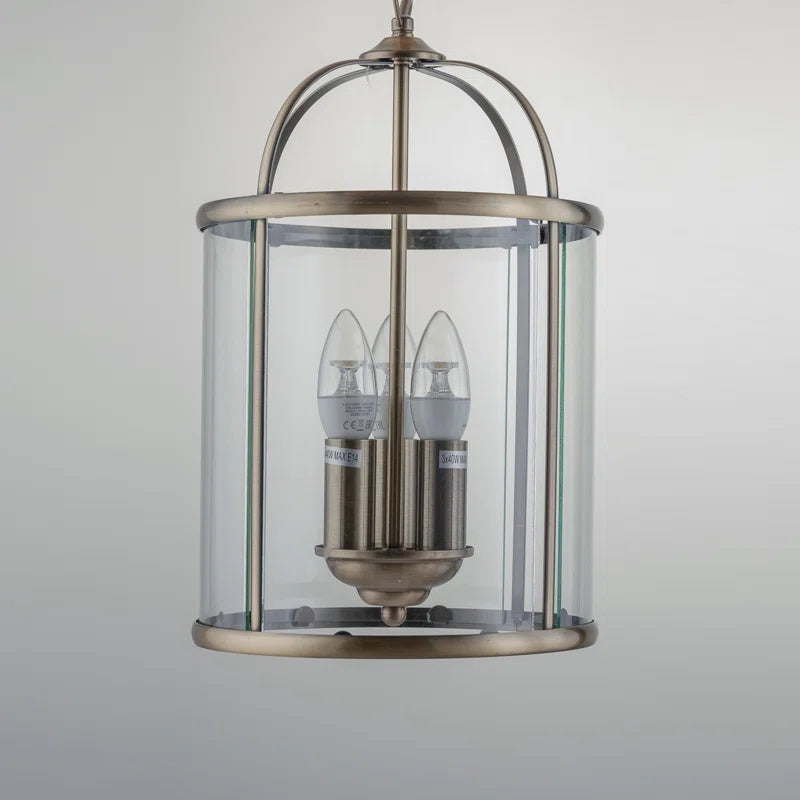 Three-light lantern pendant by TheChandelierCo featuring a classic design with metal frame and glass panels, hanging from a ceiling mount.