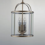 Three-light lantern pendant by TheChandelierCo featuring a classic design with metal frame and glass panels, hanging from a ceiling mount.