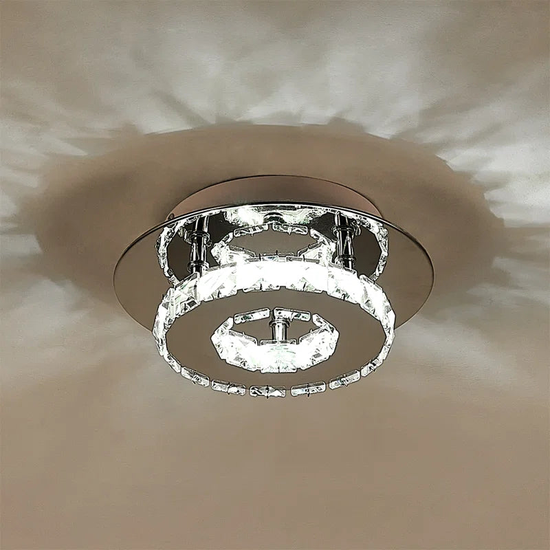 Tarren Glass LED flush mount ceiling light by TheChandelierCo featuring a modern glass design and sleek metal finish.