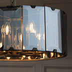 Tedrow 8 light drum chandelier by TheChandelierCo featuring a modern drum shade and metal frame, hanging with chain links.
