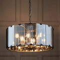 Tedrow 8-light drum chandelier by TheChandelierCo featuring a modern drum shade with warm metal accents, hanging from a sleek ceiling mount.
