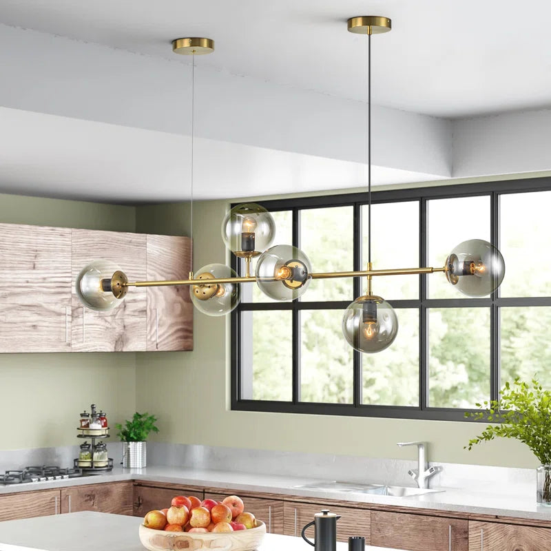 Light gold Worthington 6 linear Sputnik chandelier with globe glass bubbles, ideal as a kitchen island pendant lamp.
