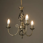 Zoey 3-light antique brass chandelier with traditional twist candle holders in candelabra style, elegant lighting fixture.
